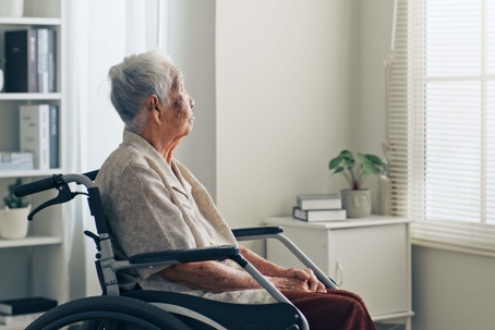old nursing home patient looking out window